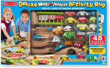Load image into Gallery viewer, Melissa &amp; Doug Deluxe Multi-Vehicle Activity Rug (39.5&quot; x 36.5&quot;) - 19 Vehicles, 12 Wooden Signs, Train Tracks